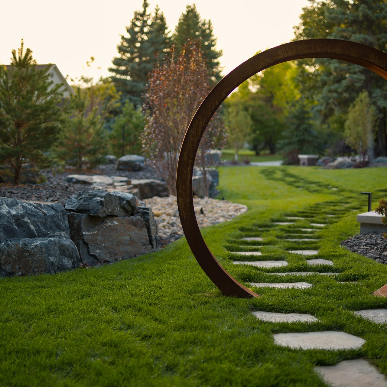 Limitless Landscaping custom landscape design featuring a stone path and circular arch in Winnipeg, Manitoba.