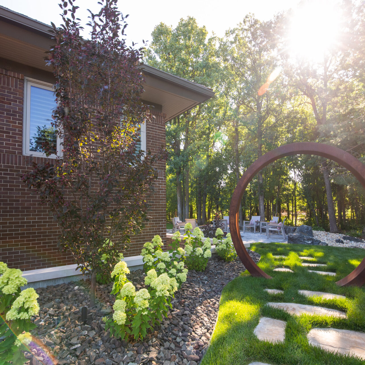 Limitless Landscaping softscaping with hydrangeas and decorative stone in Winnipeg, Manitoba landscape design project.