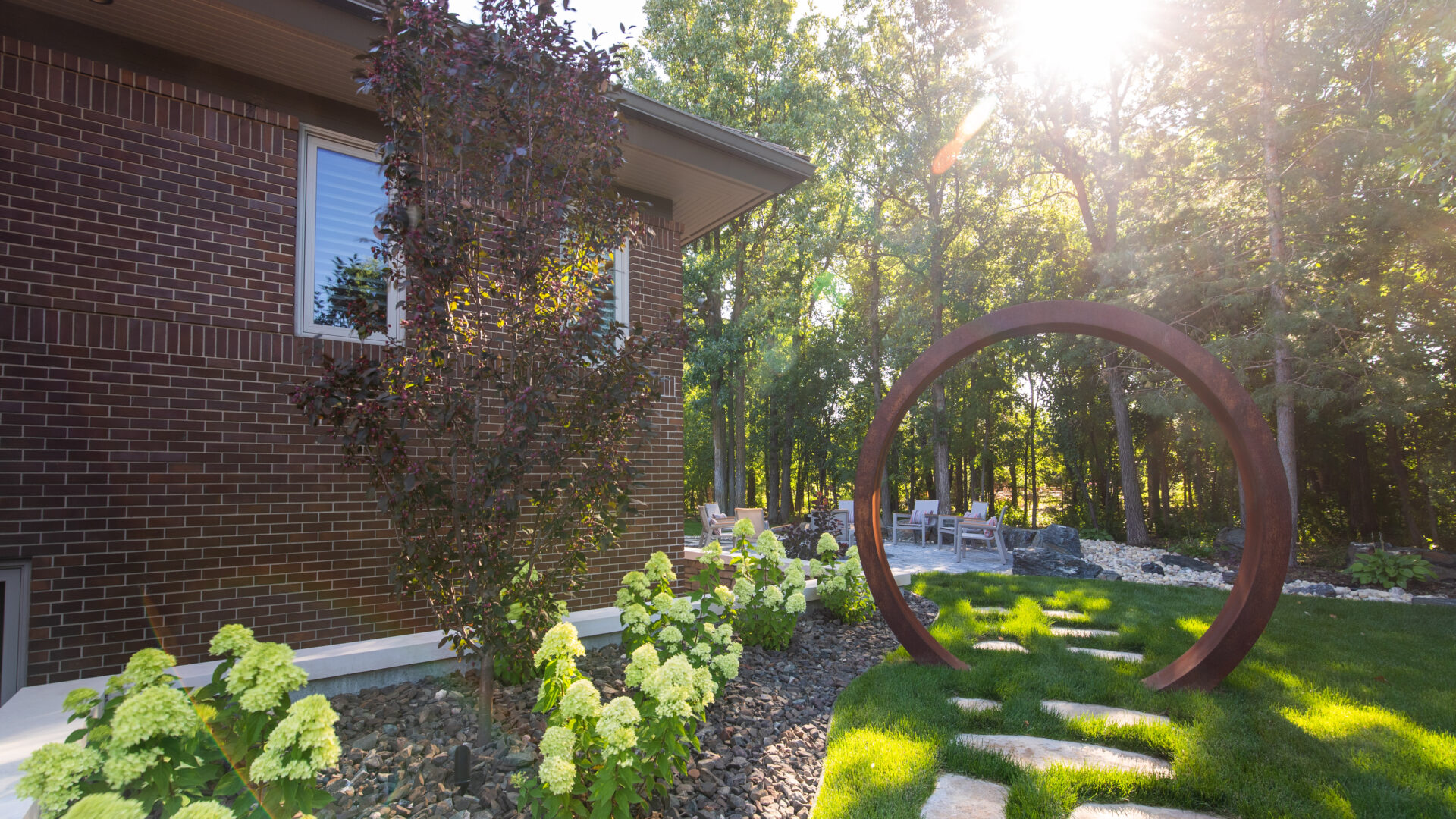Limitless Landscaping softscaping with hydrangeas and decorative stone in Winnipeg, Manitoba landscape design project.