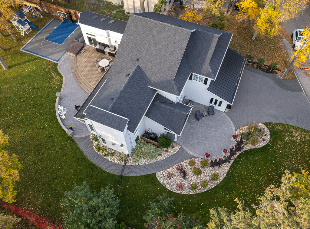 Limitless Landscaping softscaping and patio design in Winnipeg, Manitoba, featuring autumn trees view.