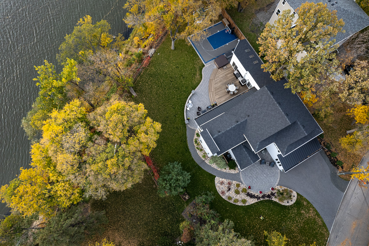 Limitless Landscaping softscaping and patio design in Winnipeg, Manitoba, featuring autumn trees and river view.