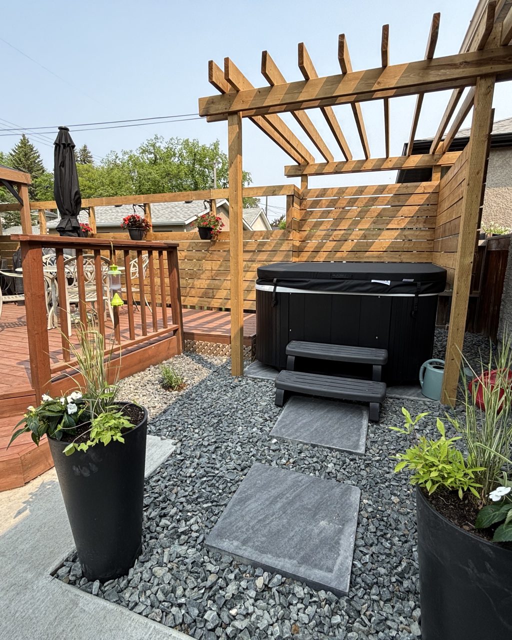 Limitless Landscaping hot tub installation with stone pathway – Winnipeg Manitoba landscape design