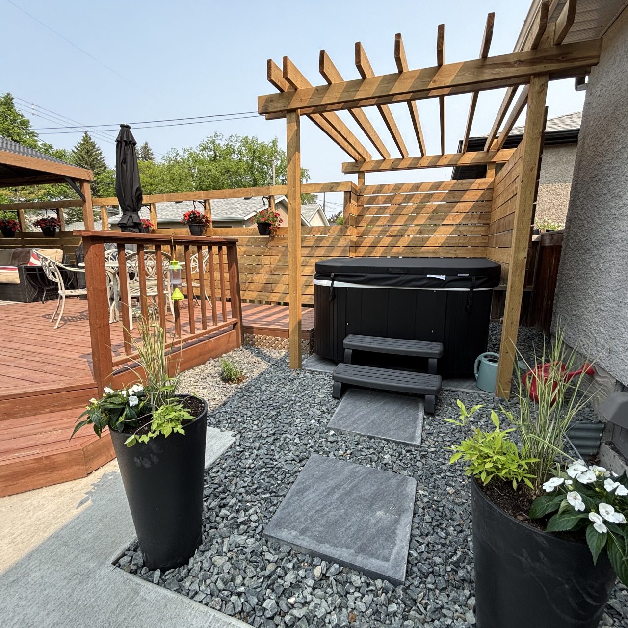 Limitless Landscaping hot tub installation with stone pathway – Winnipeg Manitoba landscape design