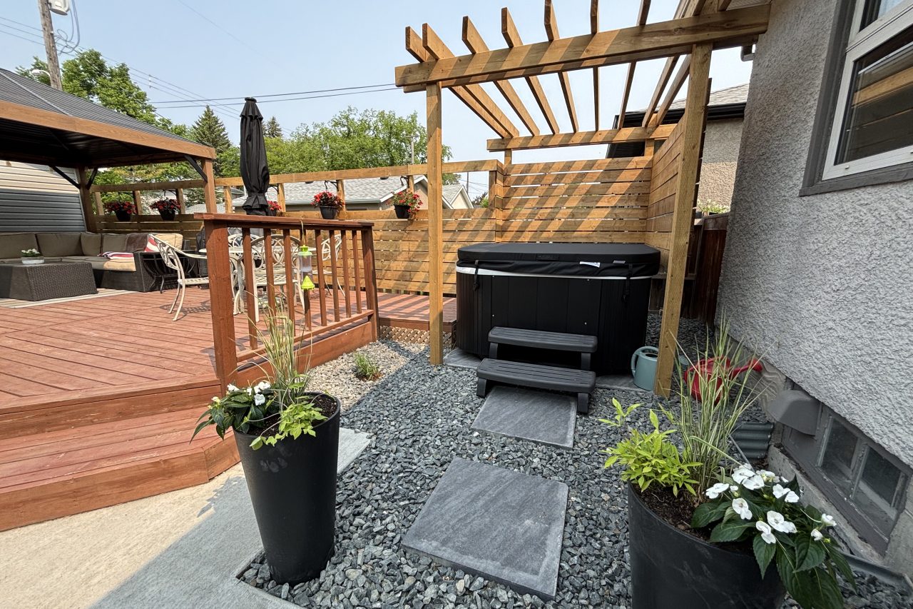 Limitless Landscaping hot tub installation with stone pathway – Winnipeg Manitoba landscape design