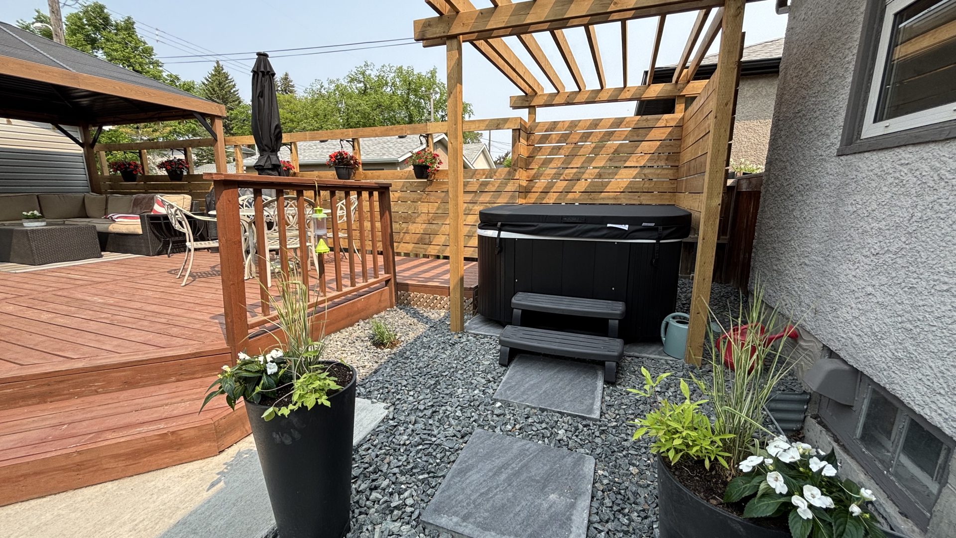 Limitless Landscaping hot tub installation with stone pathway – Winnipeg Manitoba landscape design