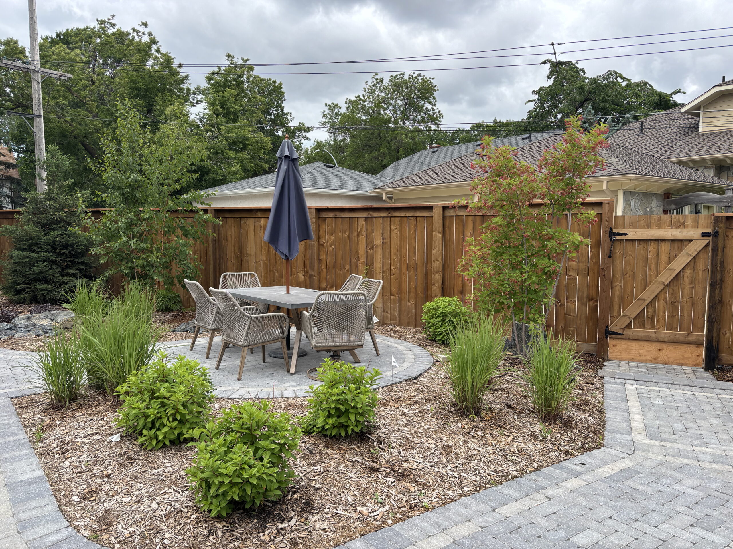 Limitless Landscaping custom patio with softscaping in Winnipeg, Manitoba.