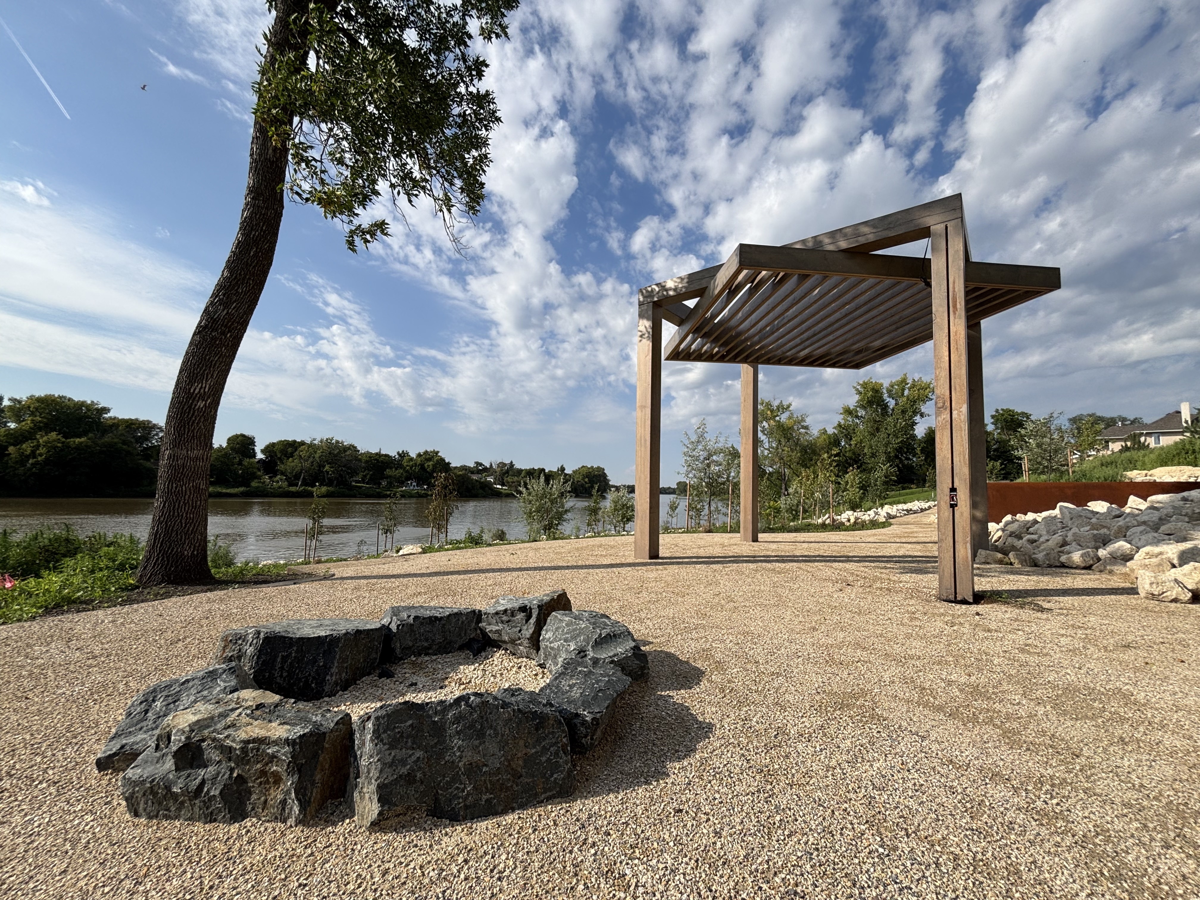 Limitless Landscaping custom hardscaping with a pergola and fire pit in Winnipeg, Manitoba